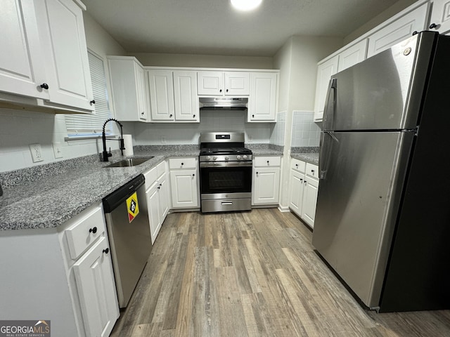 kitchen featuring white cabinets, sink, light wood-type flooring, and stainless steel appliances