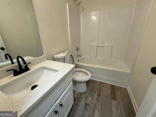 full bathroom featuring hardwood / wood-style flooring, vanity, toilet, and shower / bathing tub combination