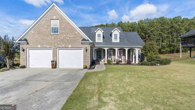 view of front of property with a front lawn, a porch, and a garage