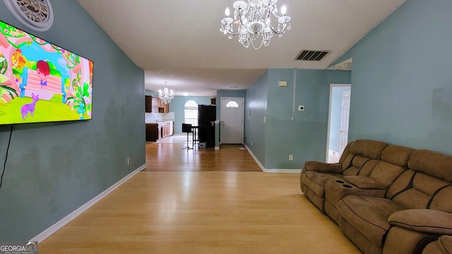 living room with a chandelier and light wood-type flooring