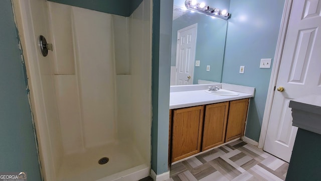 bathroom featuring a shower and vanity