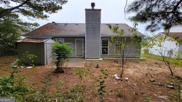 back of property featuring a patio and a storage shed