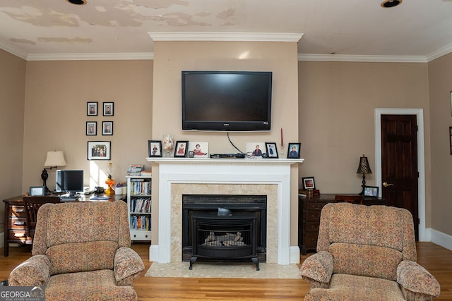 living room with light wood-type flooring and ornamental molding