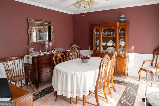 dining room featuring ceiling fan and ornamental molding