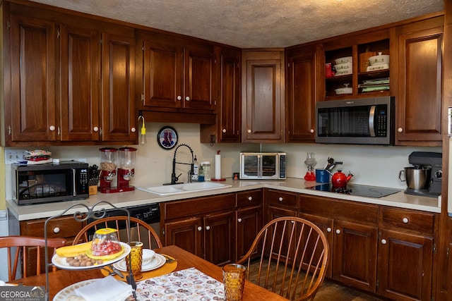 kitchen with a textured ceiling, sink, and black appliances