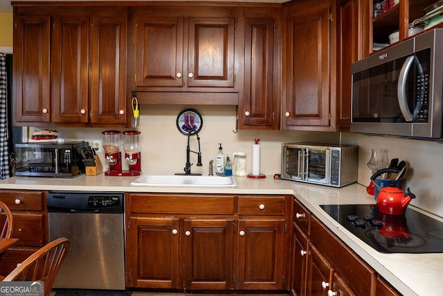 kitchen with sink and black appliances