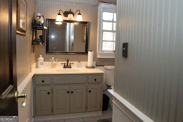 bathroom featuring tile patterned flooring, vanity, and toilet