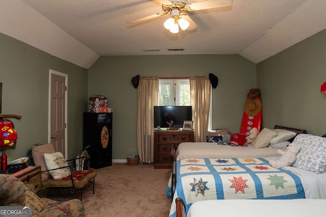 carpeted bedroom with a textured ceiling, ceiling fan, and vaulted ceiling