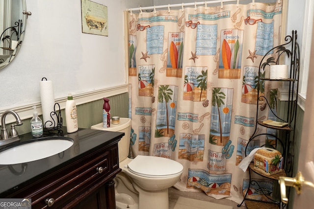 bathroom with tile patterned floors, vanity, a shower with shower curtain, and toilet