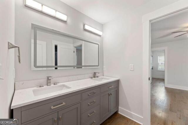 bathroom featuring vanity, ceiling fan, and wood-type flooring