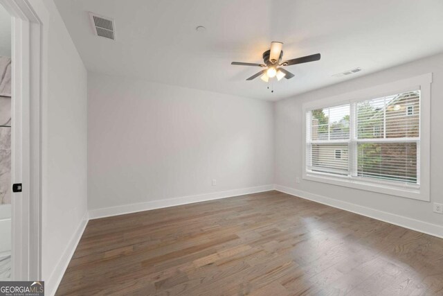 unfurnished room featuring ceiling fan and hardwood / wood-style flooring