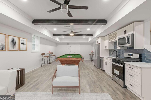 recreation room with a raised ceiling, sink, light hardwood / wood-style flooring, and pool table