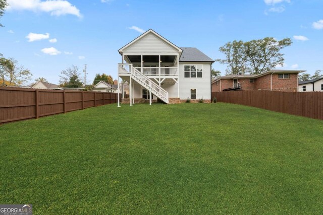 rear view of property with a yard