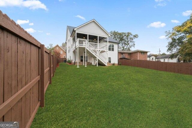 back of house featuring a lawn