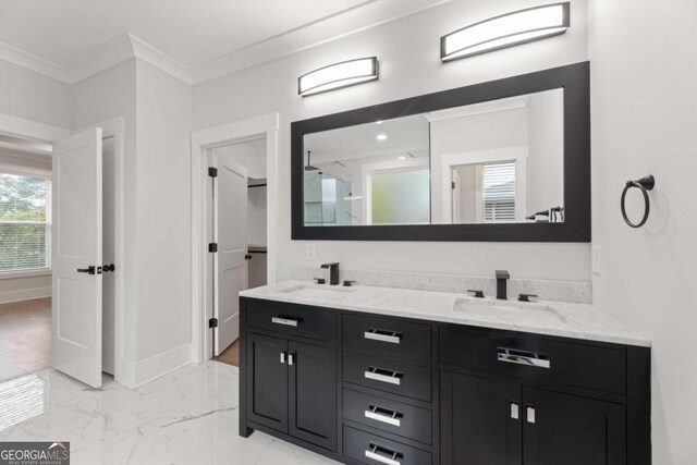 bathroom featuring walk in shower, vanity, and ornamental molding