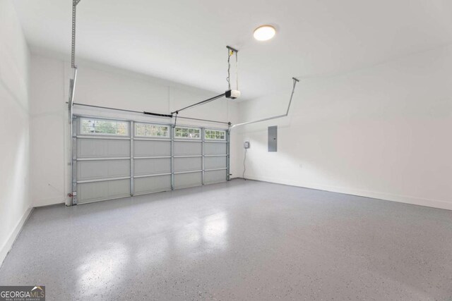 garage with electric panel and a garage door opener