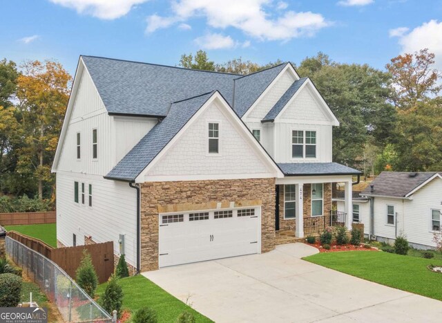 view of front of property featuring a front yard and a garage