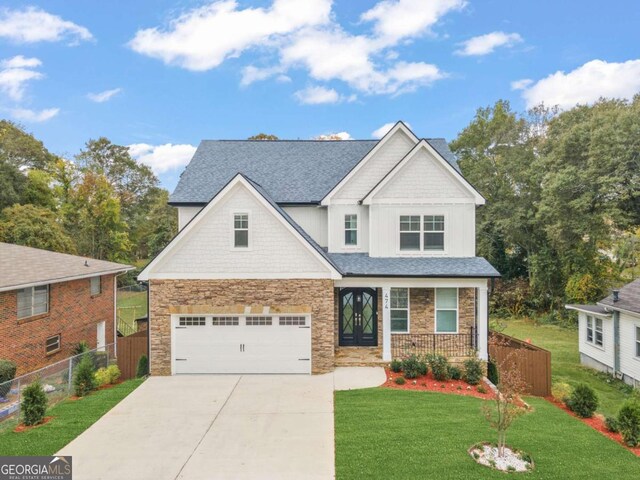 craftsman-style house featuring a front lawn and a garage