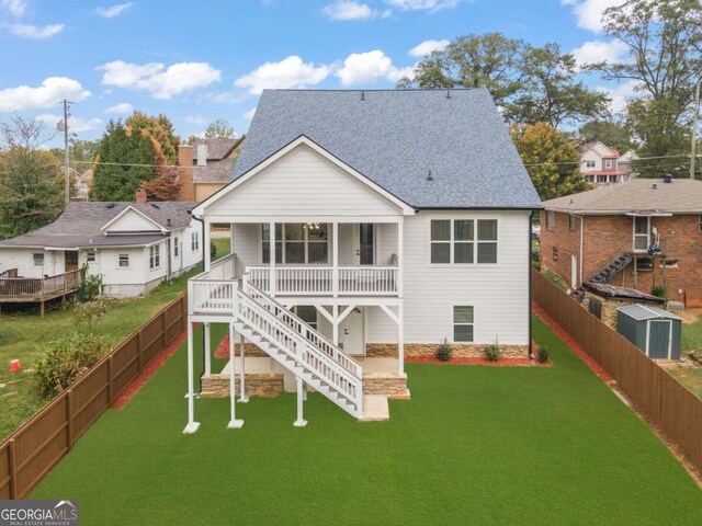 rear view of property featuring a yard