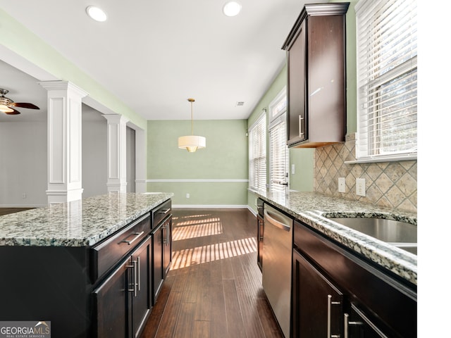 kitchen with ornate columns, ceiling fan, dishwasher, a center island, and dark hardwood / wood-style floors