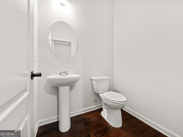 bathroom with wood-type flooring and toilet