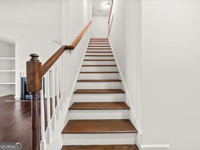 staircase with hardwood / wood-style flooring