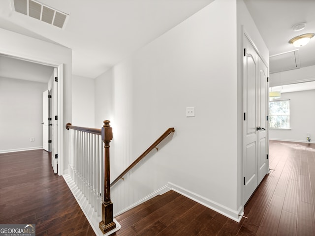 stairs featuring hardwood / wood-style floors