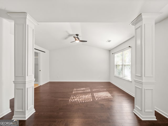 spare room with ceiling fan, lofted ceiling, dark wood-type flooring, and decorative columns