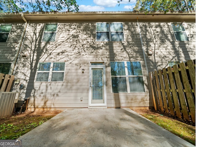 rear view of property featuring cooling unit and a patio