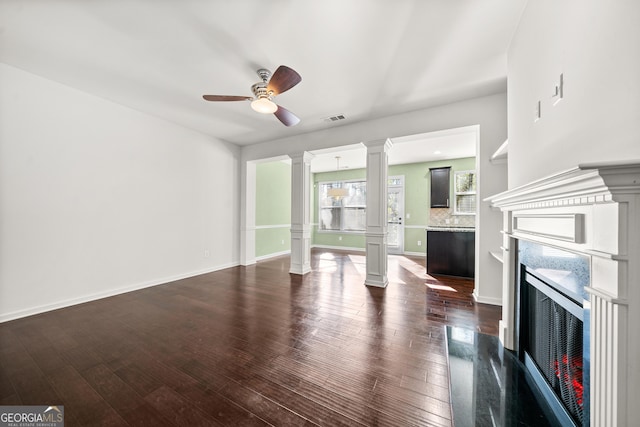 unfurnished living room featuring dark hardwood / wood-style floors, ceiling fan, and a premium fireplace