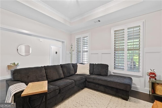 living room featuring plenty of natural light, ornamental molding, and hardwood / wood-style flooring