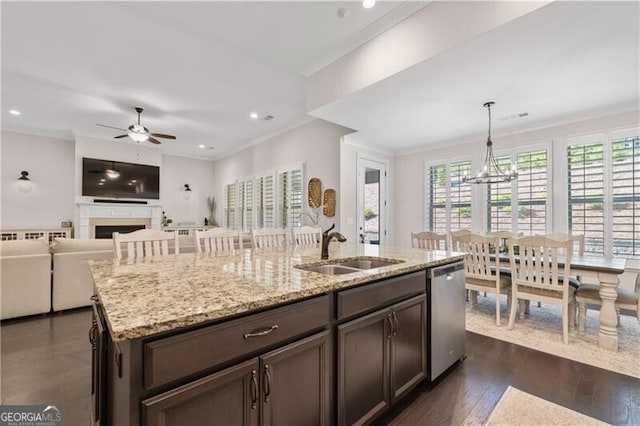 kitchen featuring a wealth of natural light, dishwasher, sink, dark hardwood / wood-style flooring, and decorative light fixtures