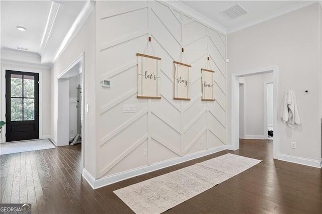 foyer entrance featuring dark hardwood / wood-style flooring and ornamental molding