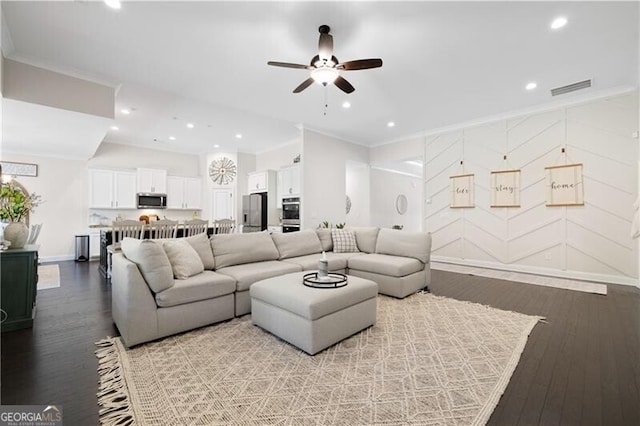 living room featuring ceiling fan, light hardwood / wood-style floors, and crown molding