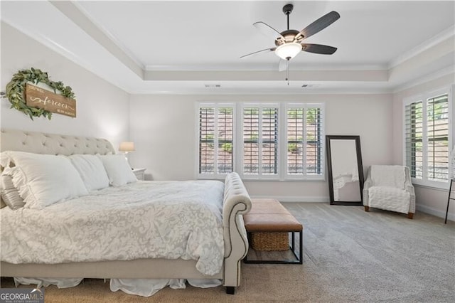 bedroom with carpet flooring, ceiling fan, a raised ceiling, and crown molding