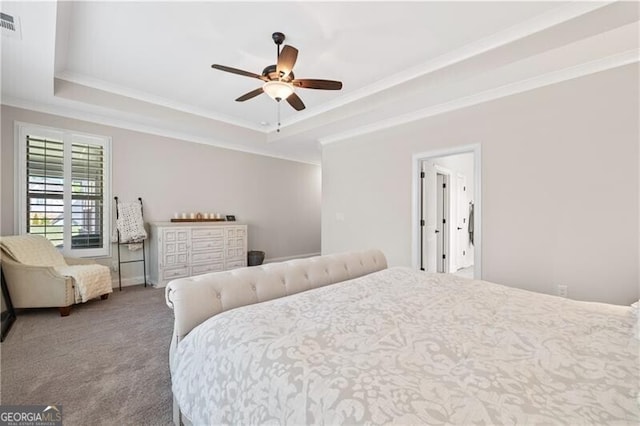 carpeted bedroom featuring a raised ceiling, ceiling fan, and crown molding