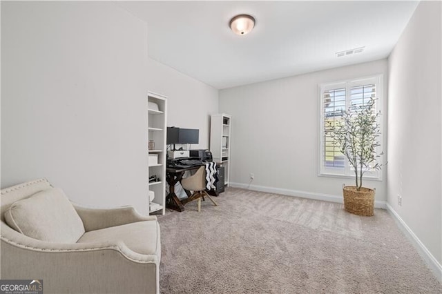 office space featuring built in shelves and carpet