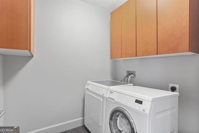 laundry area with washer and dryer and cabinets