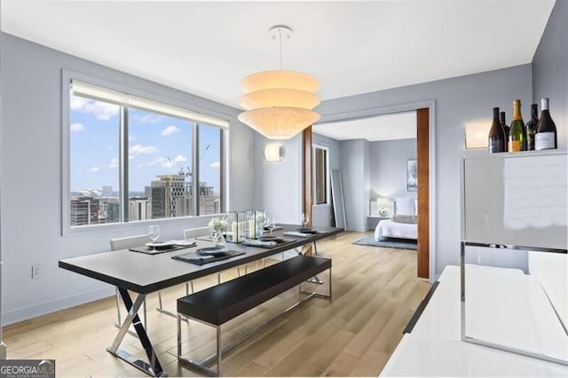 dining area featuring plenty of natural light and light hardwood / wood-style floors