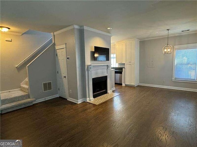 unfurnished living room featuring dark hardwood / wood-style flooring, plenty of natural light, and ornamental molding