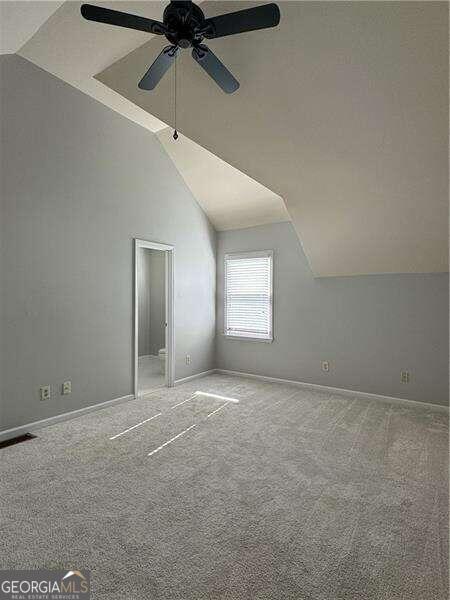 additional living space with carpet flooring, ceiling fan, and lofted ceiling