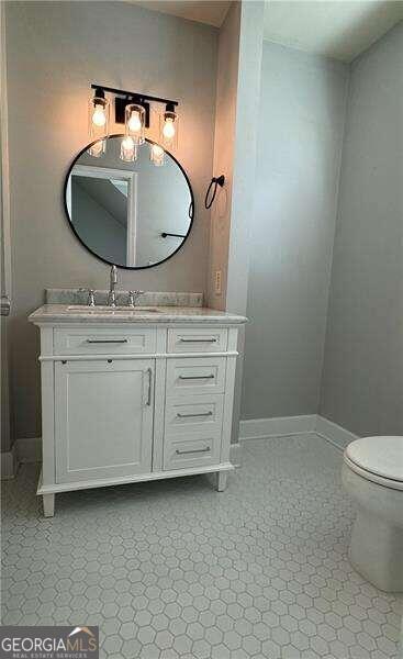 bathroom with vanity and toilet