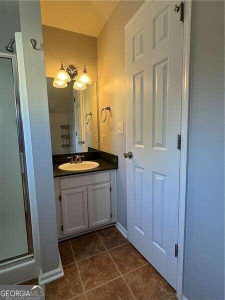 bathroom with tile patterned floors and vanity