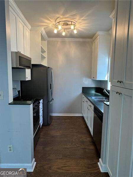 kitchen featuring white cabinets and sink