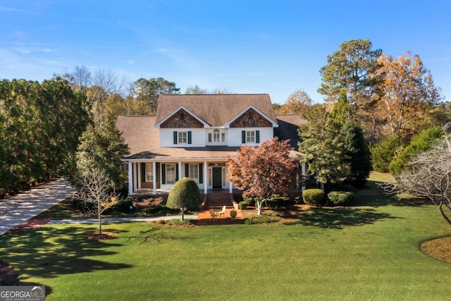 view of front facade with covered porch and a front lawn