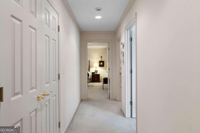 hall featuring crown molding and light carpet