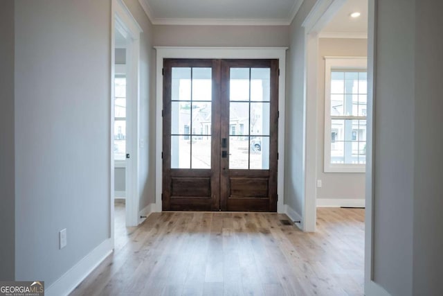 entryway with french doors, light hardwood / wood-style flooring, and crown molding