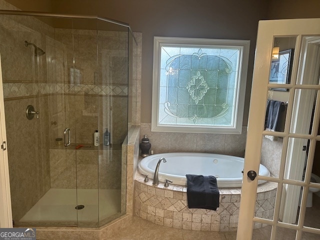 bathroom featuring plus walk in shower and tile patterned flooring