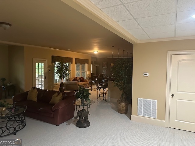 living room with a drop ceiling