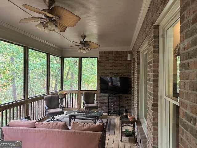 sunroom featuring ceiling fan